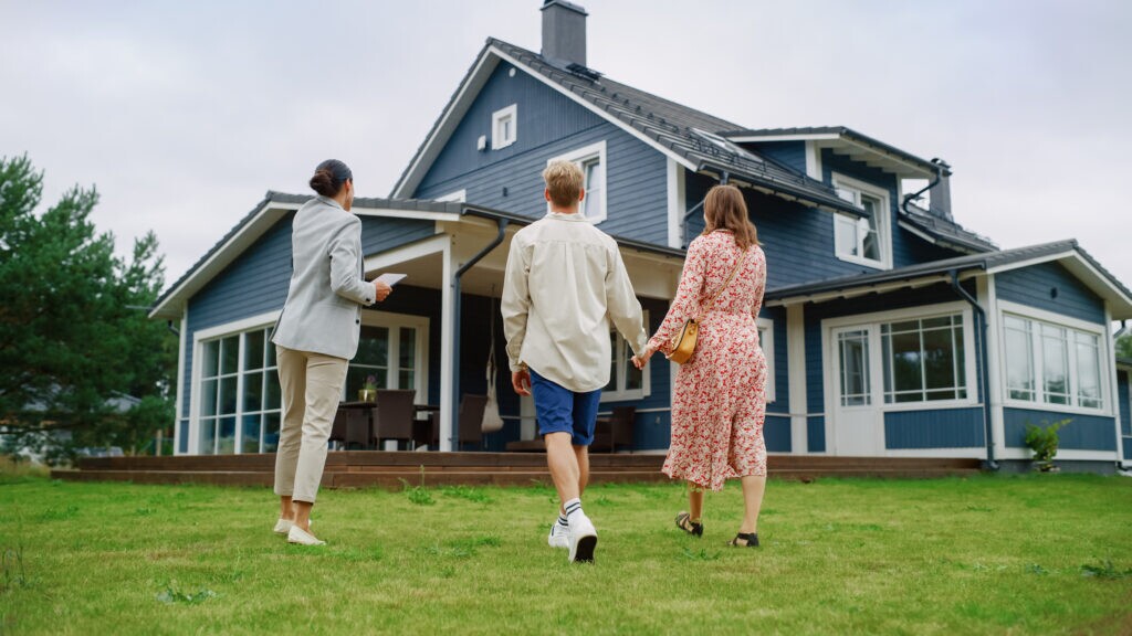Professional Realtor Showing a Hot Property Location to a Young