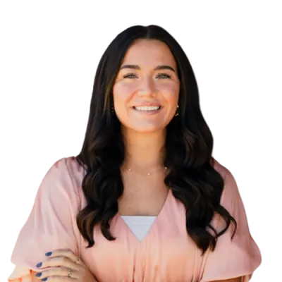 Hailey Tapp - TBG - 500x500 Hailey Tapp professional headshot wearing a light pink blouse, photographed against a neutral background with long dark hair.