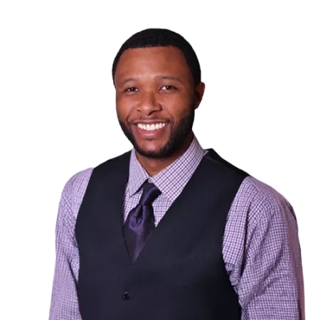 Jimmy Hicks - WBG - 500x500 Jimmy Hicks professional headshot wearing a purple checkered dress shirt, dark vest, and matching tie against a transparent background.