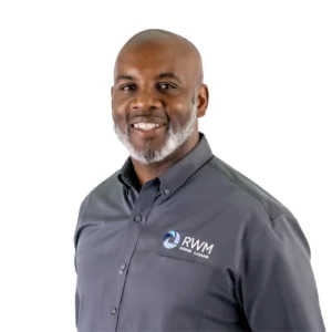 John Martin - WBG - 500x500 John Martin professional headshot wearing a gray RWM Home Loans button-down shirt against a light gray background.