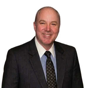 Randy Leohardt - WBG - 500x500 Randy Leohardt professional headshot wearing a dark suit and patterned tie against a light gray background.