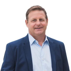 Scott Olson professional headshot wearing a navy blazer and light blue dress shirt against a clean, neutral background.