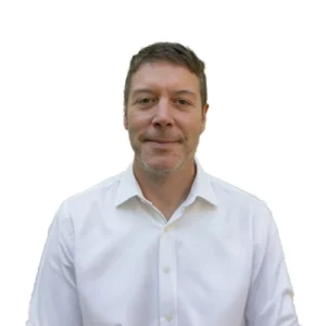 Sean Flannery - WBG - 500x500-01 Sean Flannery professional headshot wearing a white dress shirt against a light neutral background.