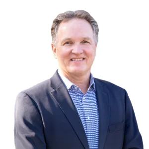 Sean Kelly - WBG - 500x500 Sean Kelly professional headshot wearing a navy blazer and blue checkered dress shirt against a light neutral background.