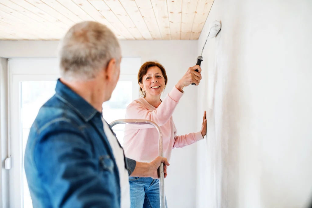 cheerful-couple-painting-home-interior-wall-togeth-2026-01-05-06-07-56-utc