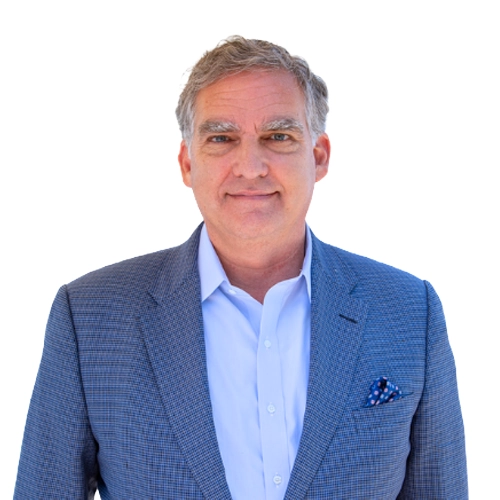 Joe Varisco professional headshot wearing a dark business suit, white dress shirt, and gray tie against a light gray background.